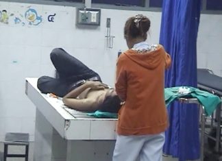 Theerapong Boonmak is treated for knife wounds in a Pattaya hospital after being attacked in the early hours of Monday morning.